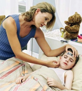 Young Woman Taking Sons Temperature